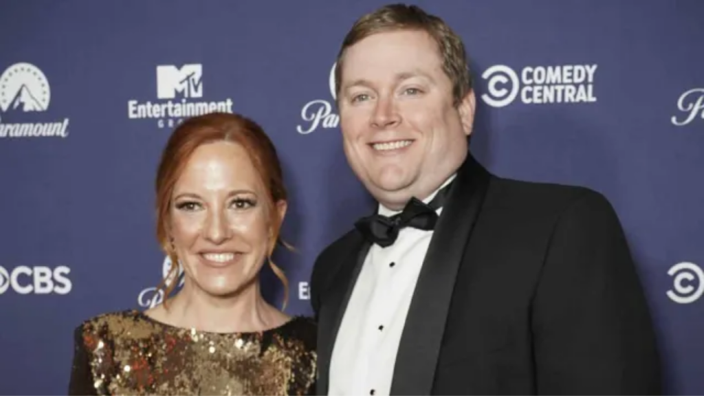 Candid photo of Gregory Mecher with his spouse Jen Psaki sharing a smile.