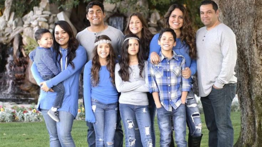 Isaac Ortega and Jenna Ortega sharing a candid moment at a family event.